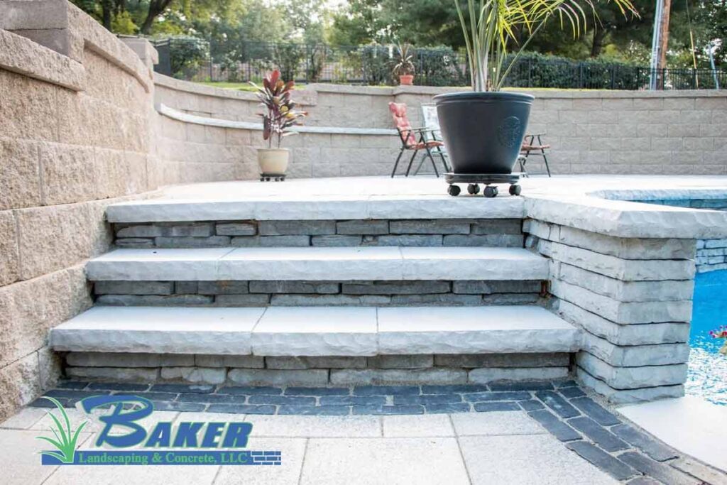 Stone steps leading to a patio area with potted plants near a pool