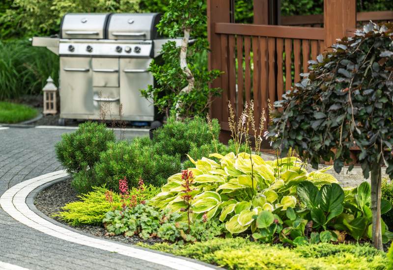 Backyard outdoor landscaping designed with small planting beds in St. Louis metro area